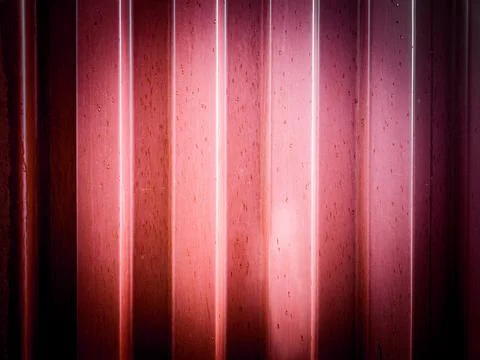 A close-up view reveals the textured surface of a red corrugated metal wall,  Stock Photos