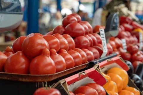 Close-up view of ripe red tomatoes, neatly arranged at a vegetable stall. Stock Photos