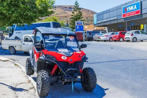 Close-up view of off road buggy parked near SYNKA supermarket on sunny street. Stock Photos