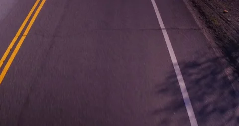 Close up view of road from moving car Stock Footage 136341145