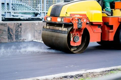 Close view on the road roller working on the new road construction site Stock Photos