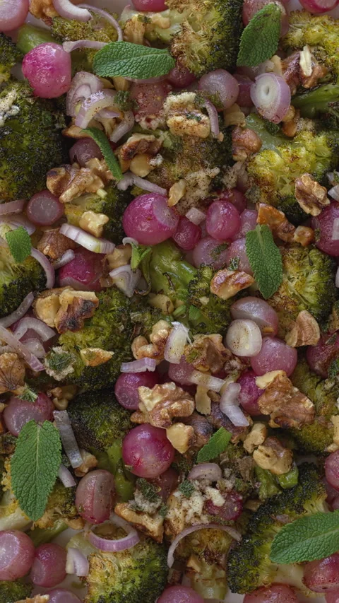 Close-up view of roasted broccoli and radish salad background. Vertical video. Stock Footage 310624003
