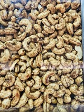 A close-up view of roasted cashew nuts, displayed in a dense glass, highlig.. Stock Photos