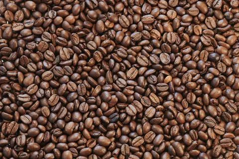 Close view of roasted coffee beans ready to be ground and infuse Stock Photos