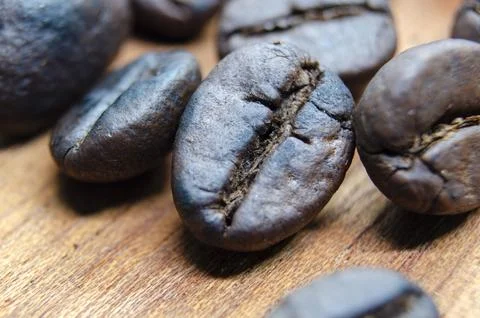 Close up view roasted coffee beans that highlights the texture and surface .. Stock Photos