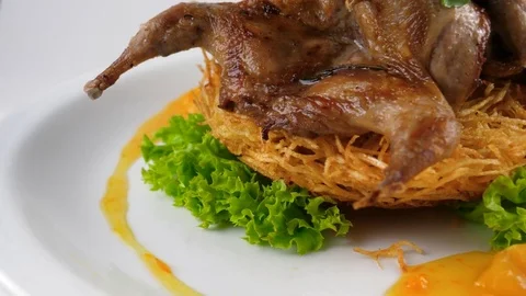 Close-up view of Roasted quail, decorated with roasted potato and vegetables Stock Footage 80142602