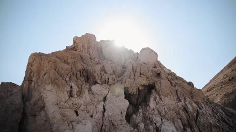 Close up view of rock. Sunlight is in the clear blue sky. Mountain rock in Stock Footage 181645041