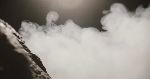 Close up view of rocks in the thick smoke on a dark background. Slow motion Stock Footage 158298506