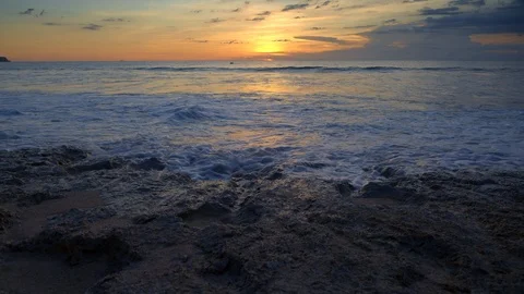 Close up view of rocky beach with big tide waves during warm sunset Video stock 115054050