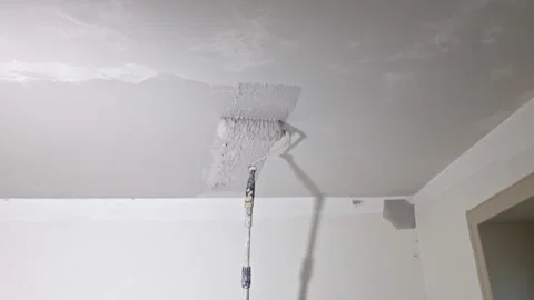 Close up view of roller applied skim coat on ceiling during room renovation. Stock Footage 327672829
