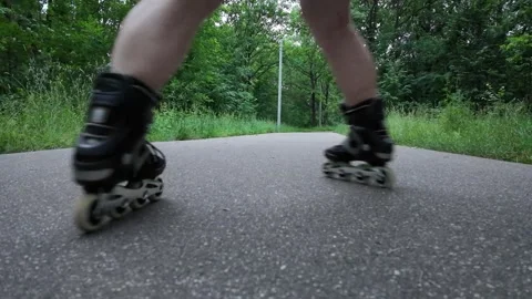 Close-up view of roller skates in action on a smooth path in nature Video stock 338307030