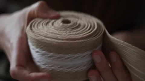 Close Up view of rolling up jute braid. Boho rustic textile Homemade decor. Stock Footage 151974324