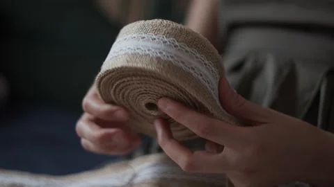 Close Up view of rolling up jute braid. Boho rustic textile Homemade decor. Stock-Footage 151974902