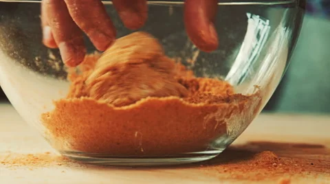 Close-up view of rolling raw meat chops in glass bowl full of spices and brea Stock Footage 65114468