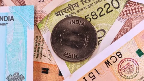 Close up view of rotating 10, 20, 50, 200, 500 Indian rupees, notes and coins. Stock Footage 296428980