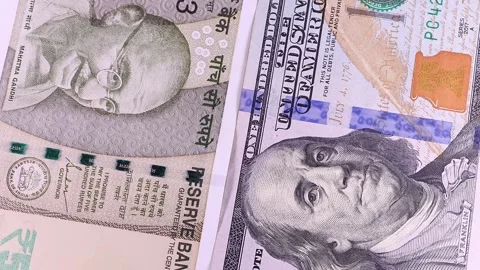 Close up view of rotating 500 Indian rupees and 100 USD american dollars. Stock Footage 296428077