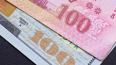 Close up view of rotating American dollar (USD) and Thai baht (THB) banknotes. Stock Footage 309829063