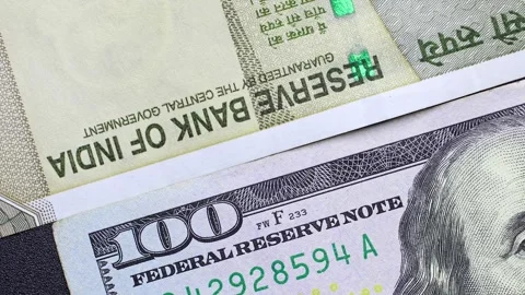 Close up view of rotating American dollar and Indian rupee banknotes. Stock Footage 309894532