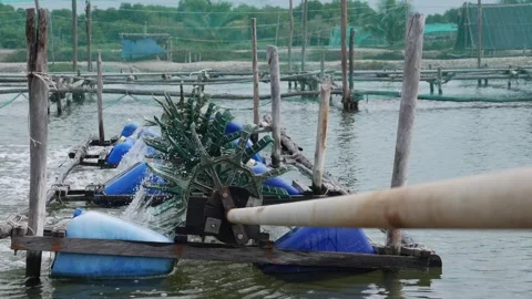 Close view of rotating impeller paddles breaking water surface at aquaculture Stock Footage 322166561