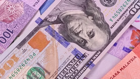 Close up view of rotating Malaysian ringgit (MYR) and 100 USD american dollars. Stock Footage 297160069