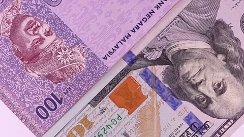 Close up view of rotating Malaysian ringgit (MYR) and 100 USD american dollars. Stock Footage 297175119
