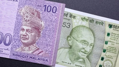 Close up view of rotating Malaysian ringgit and Indian rupee banknotes. Stock Footage 309894704