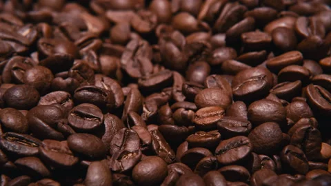 Close-up view of rotating roasted coffee beans, Stock Footage 286387224
