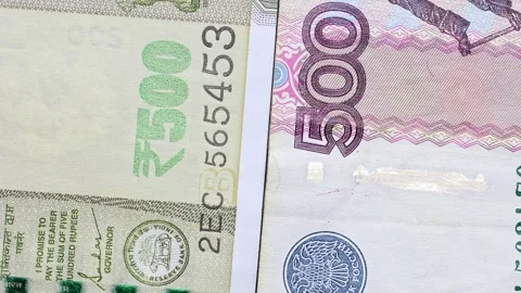 Close up view of rotating Russian ruble and Indian rupee banknotes. Stock Footage 309815570