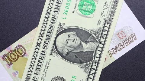 Close up view of rotating Russian ruble and American Dollar banknotes. Stock Footage 309820273