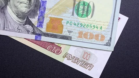 Close up view of rotating Russian ruble and American Dollar banknotes. Stock Footage 309825638