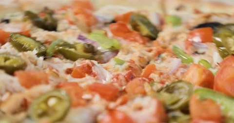 Close-up view of rotating tasty pizza with bacon and vegetables. Stock Footage 105307687