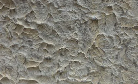 Close up view of rough grey stucco wall with uneven texture and decorative .. Foto stock