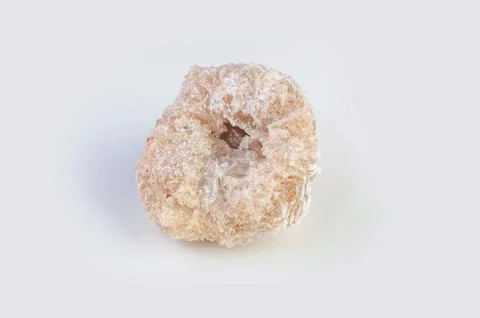 Close-up view of a rough, pale geode with a hollow crystalline center on a .. Stock Photos