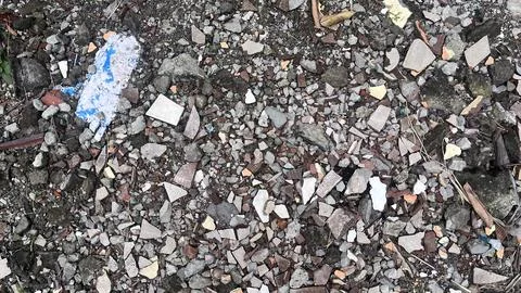 Close up view of a rough, uneven ground surface scattered with small rocks, b Stock Photos