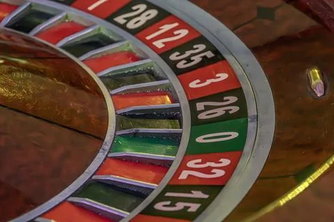 Close-up view of a roulette wheel inside a casino Red and black segments with Stock Photos