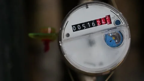 Close Up View of a Round Water Meter With Spinning Black and Red Numerical Stock Footage 328533545