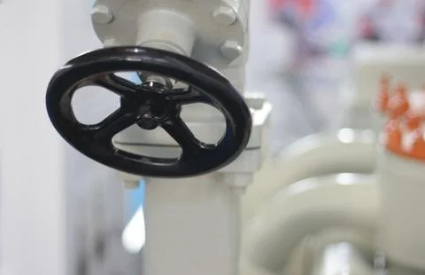 Close-up view of round wheel handle of an equipment in an industry Stock Photos
