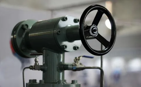 Close-up view of round wheel handle of an equipment in an industry Stock Photos