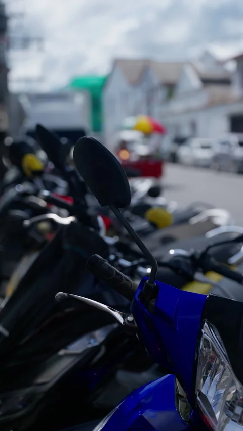 Close-up view of a row of parked motorcycles on a city street during daylight Video stock 312203885