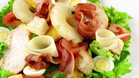 Close-up view of royal Caesar salad with chicken breast, pineapple, quail eggs Vídeos de archivo 73507947