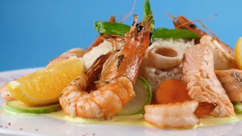 Close-up view of Royal Seafood dish, shrimps, salmon and squid with rice Stock Footage 78668545