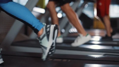 Close up view of running foots on treadmill machine in gym shoes girl sport Stock Footage 88176863