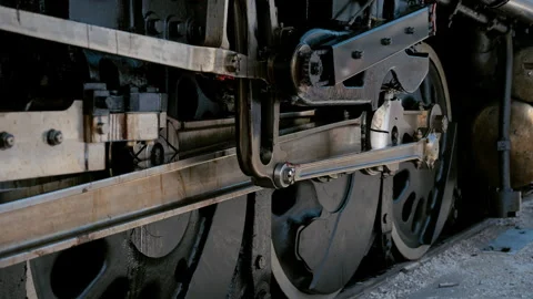 Close up view of the running gear and driving wheels on steam locomotive Stock Footage 340382874