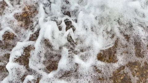 Close up view of rushing river water creating thick white foam and churning Stock Footage 346012719