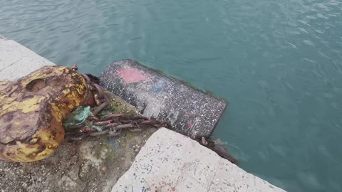 Close View of Rusted Bollard and Chain on Concrete Dock by Sea Stock Footage 338106070