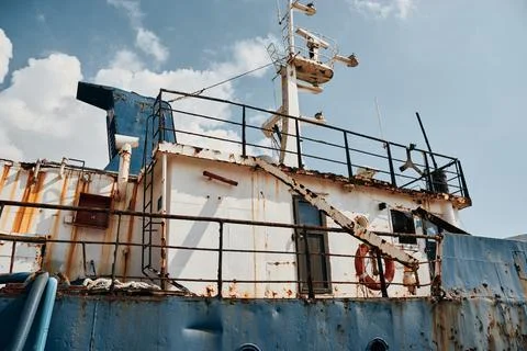 Close-up view of the rusted superstructure and deck of an old abandoned ship Stock Photos