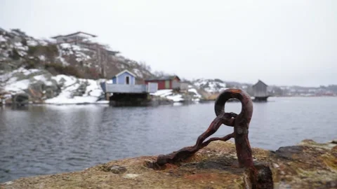 Close view of a rusty hook on a broken stone pier one cloudy day in the sprin Stock Footage 150049242