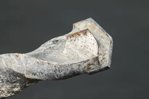 Close-up view of a rusty metal drill bit showing intricate details Фото