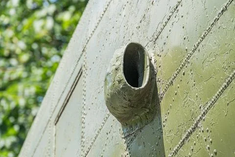 Close-up view of a rusty, perforated metallic circular object with a centra.. Stock Photos