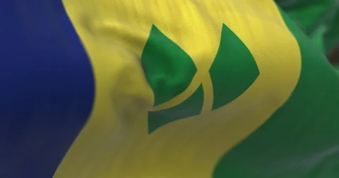 Close-up view of Saint Vincent and the Grenadines national flag waving Stock Footage 231331427